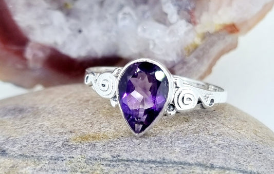 Amethyst teardrop gem with swirling band sterling silver ring.